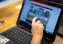  Students hand touching the screen